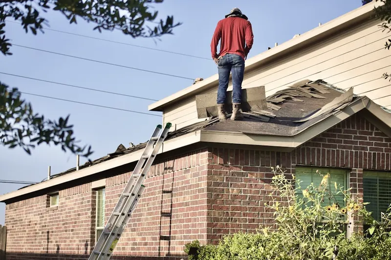 Professional roofer working on a residential roof in Indian Creek Village